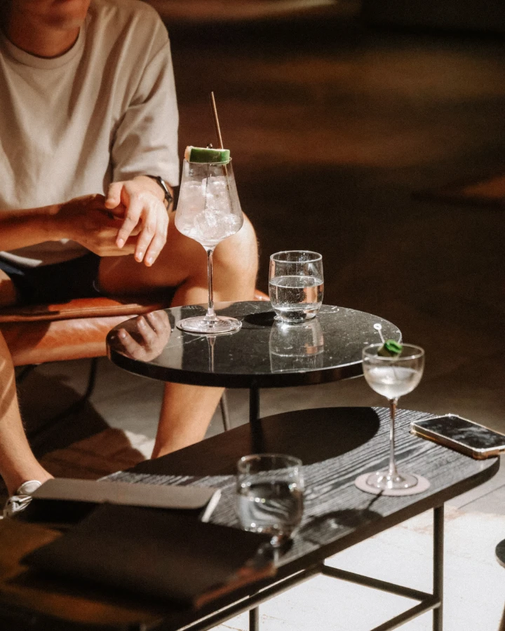 man sitting beside drinks on a table