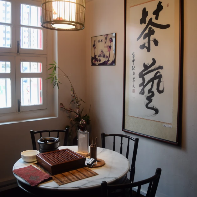 antique style chinese tea shop interior with a small round table and three chairs
