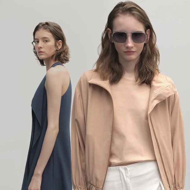 a woman modelling an orange jacket and another woman modelling a blue dress