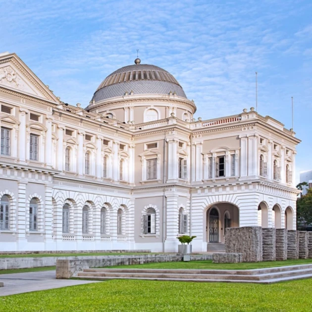 large historical building with a flat green lawn