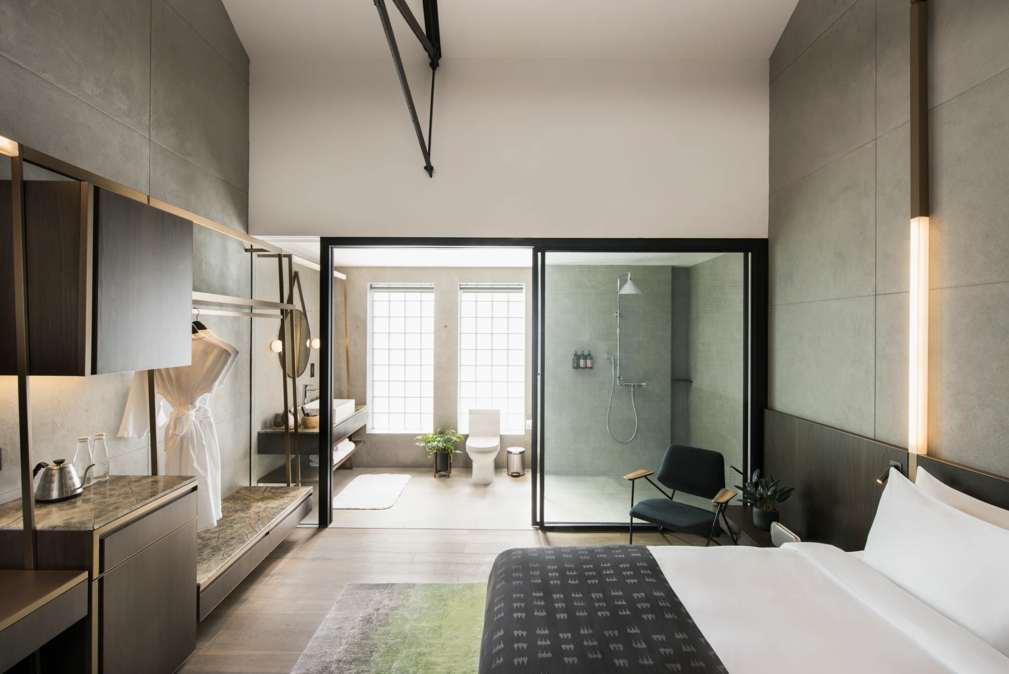 spacious modern hotel bedroom with attached bathroom