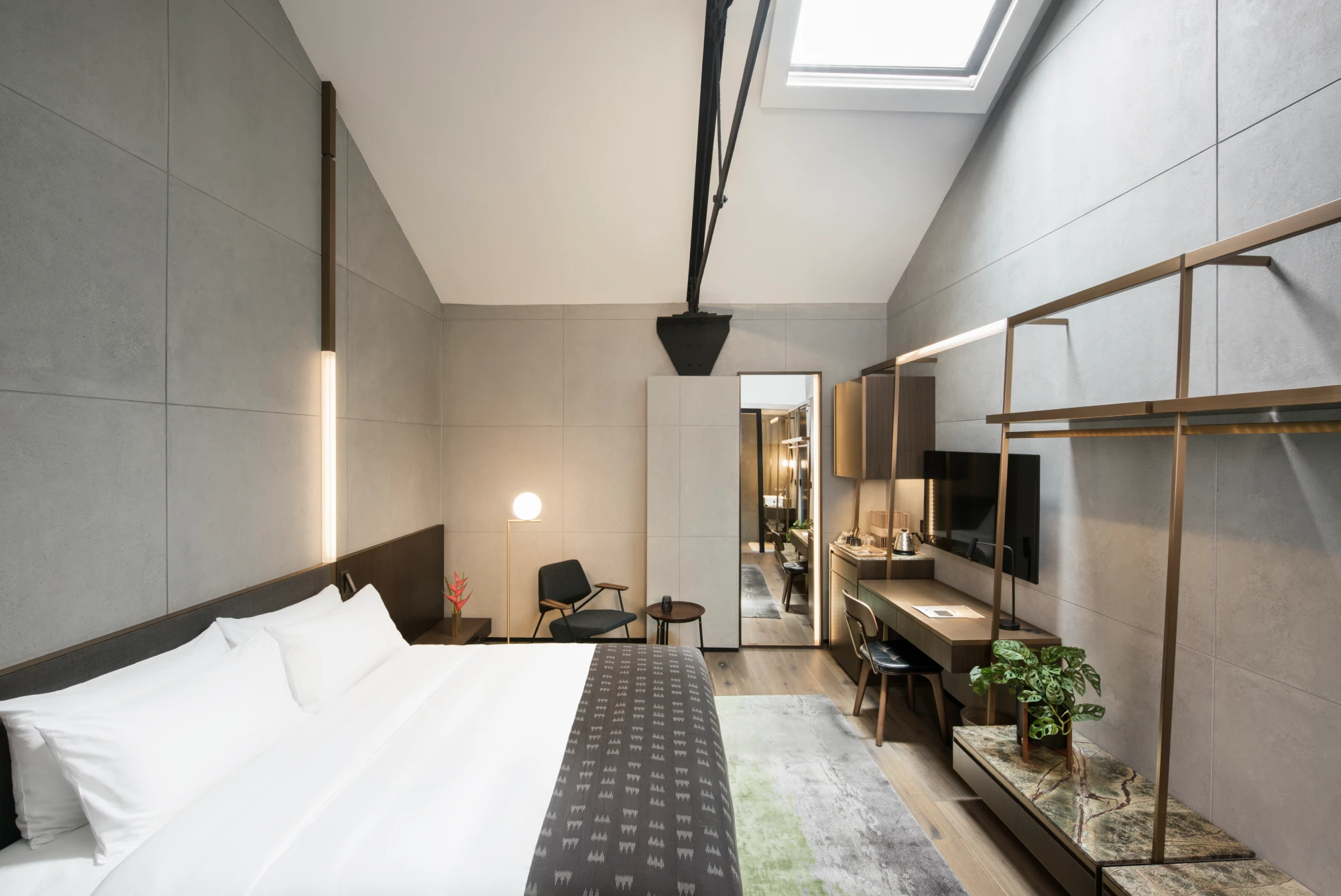 modern hotel bedroom with skylight above the warbdrobe