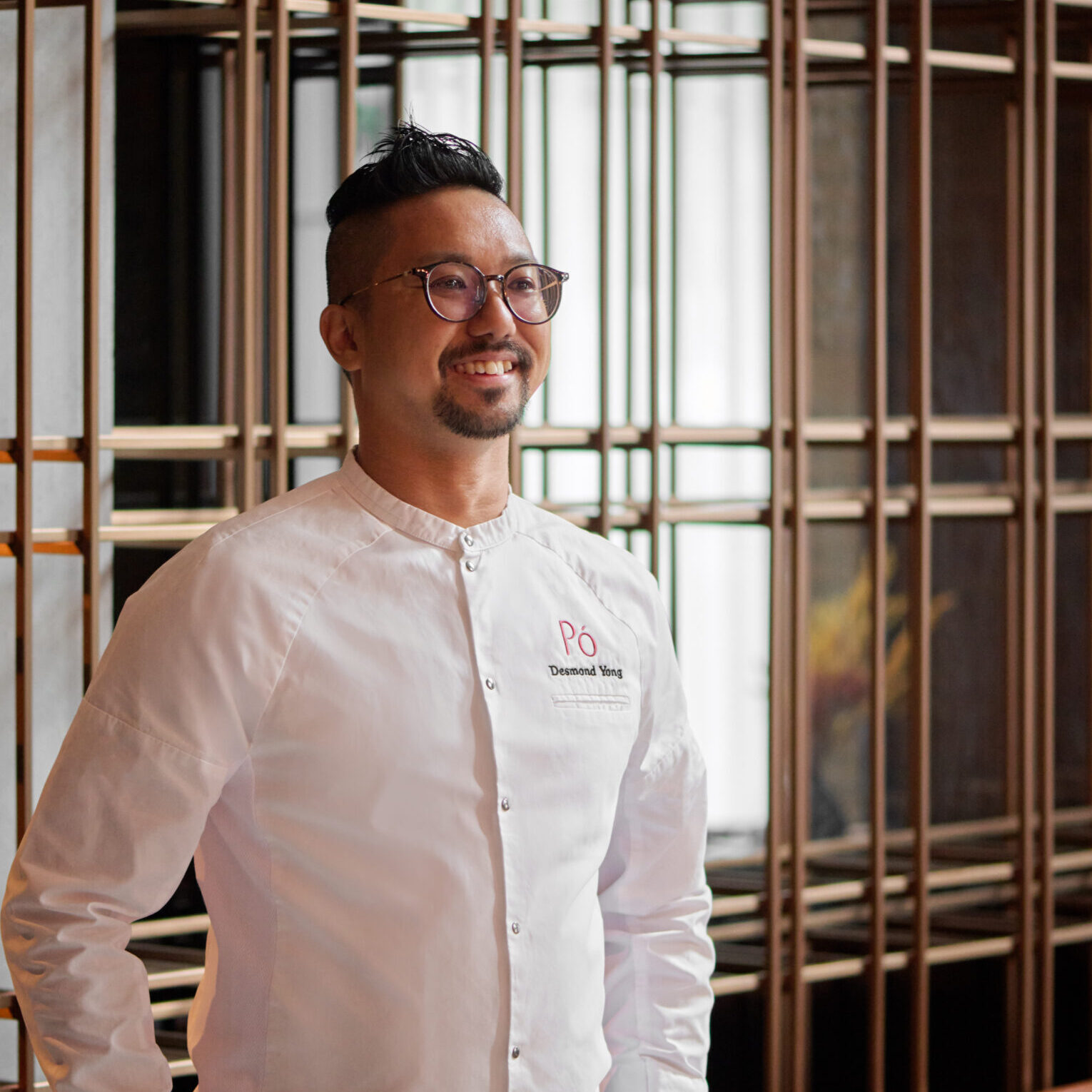 HIRES DESMOND HEAD CHEF 511 man in chef uniform standing while smiling