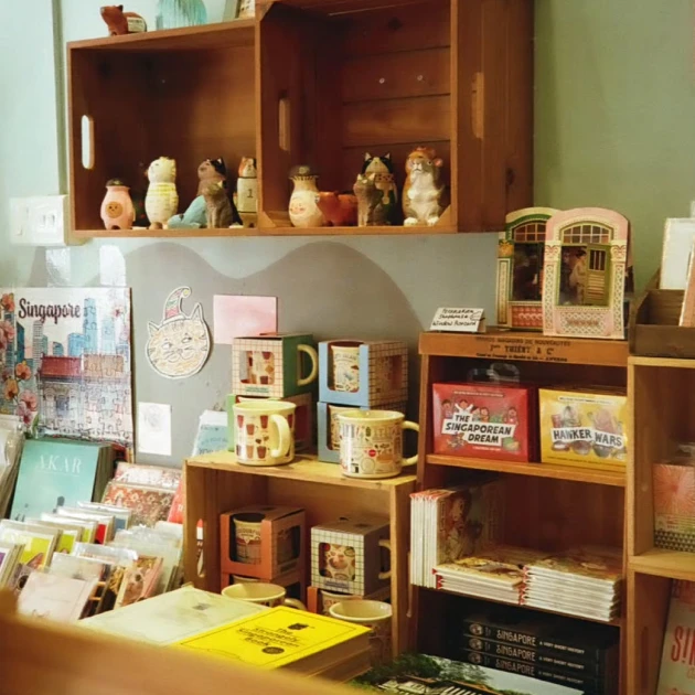 vintage souvenir shop displaying books, mugs, and cat figurines