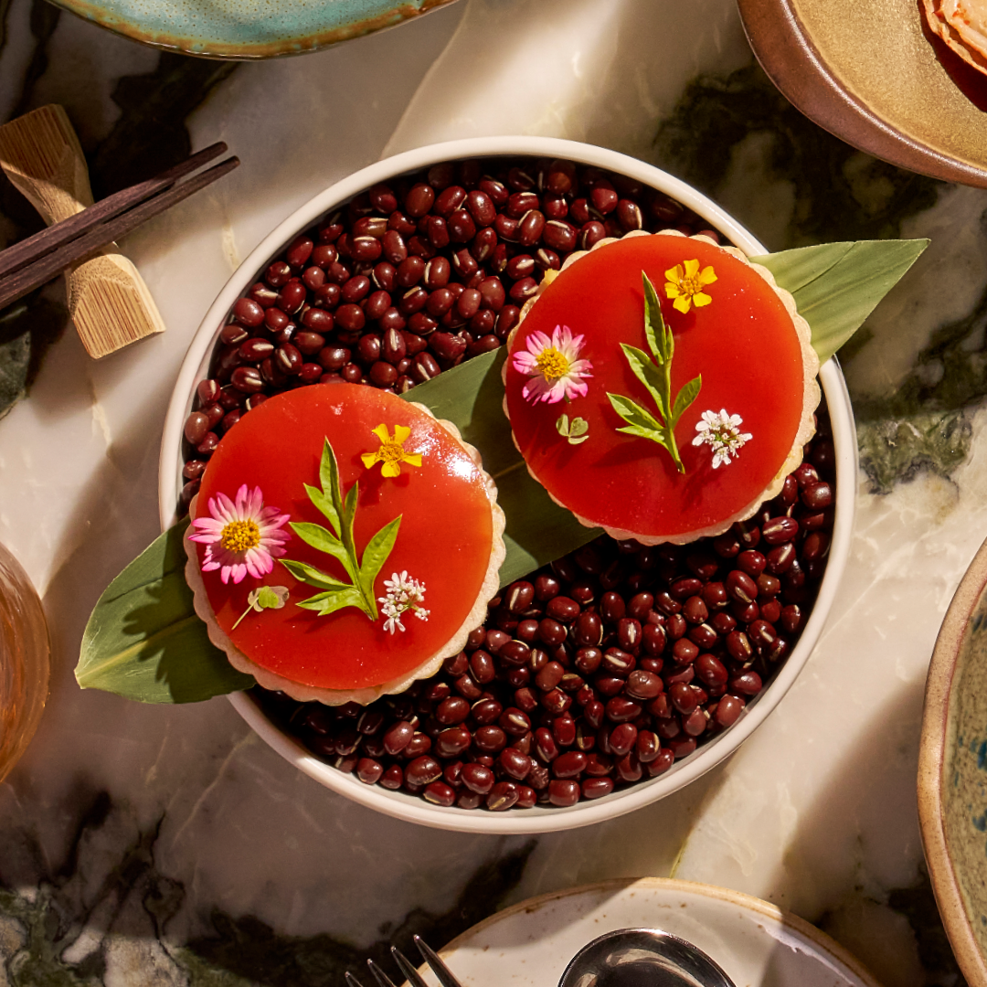 two desserts on a leaf on a bowl on red beans