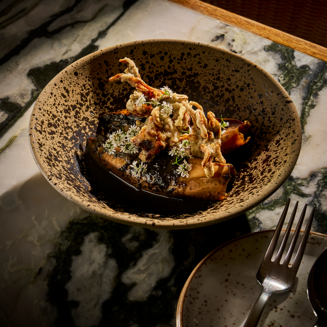 squid dish in a bowl on a marble table