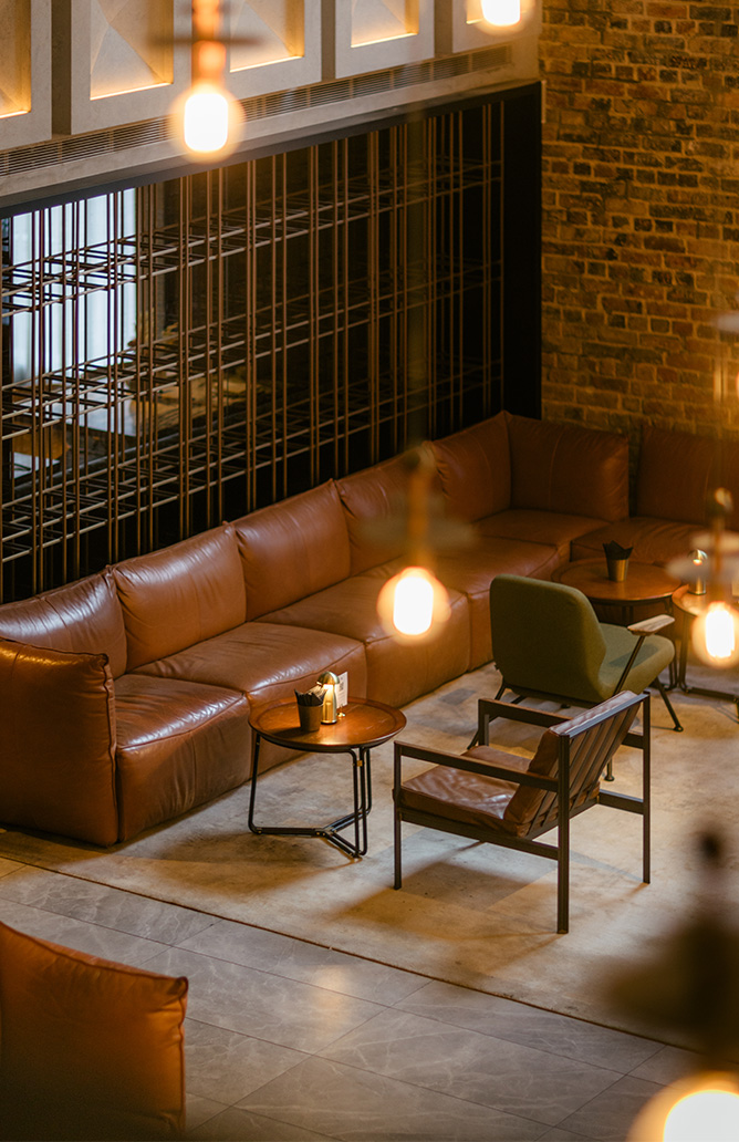 industrial style lounge area with brown leather sofa