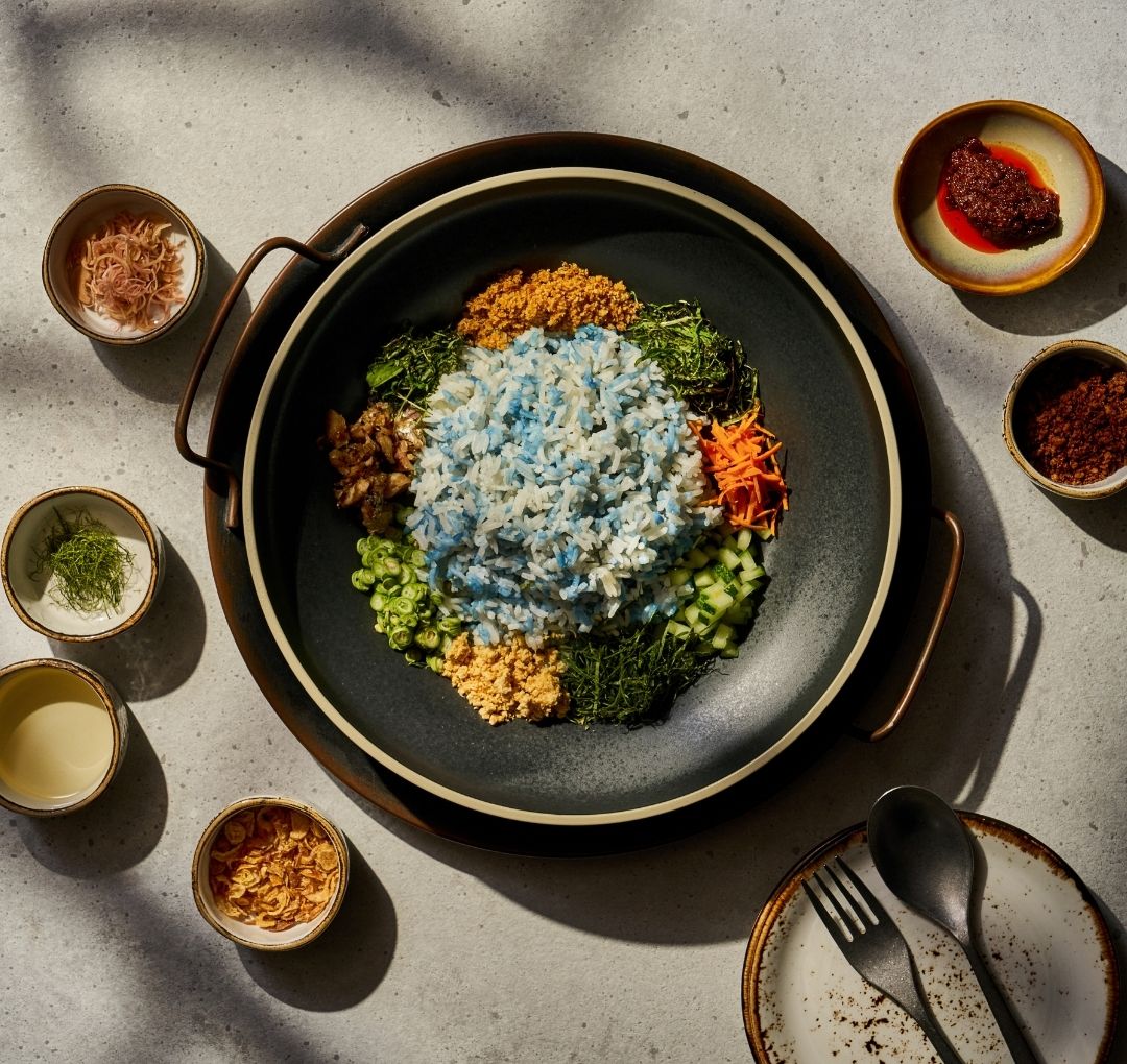 peranakan food. nasi ulam, delicious blue pea rice with herbs